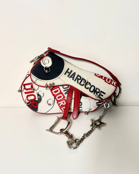 AVAILABLE | Christian Dior Hardcore Canvas Pierced Saddle Bag